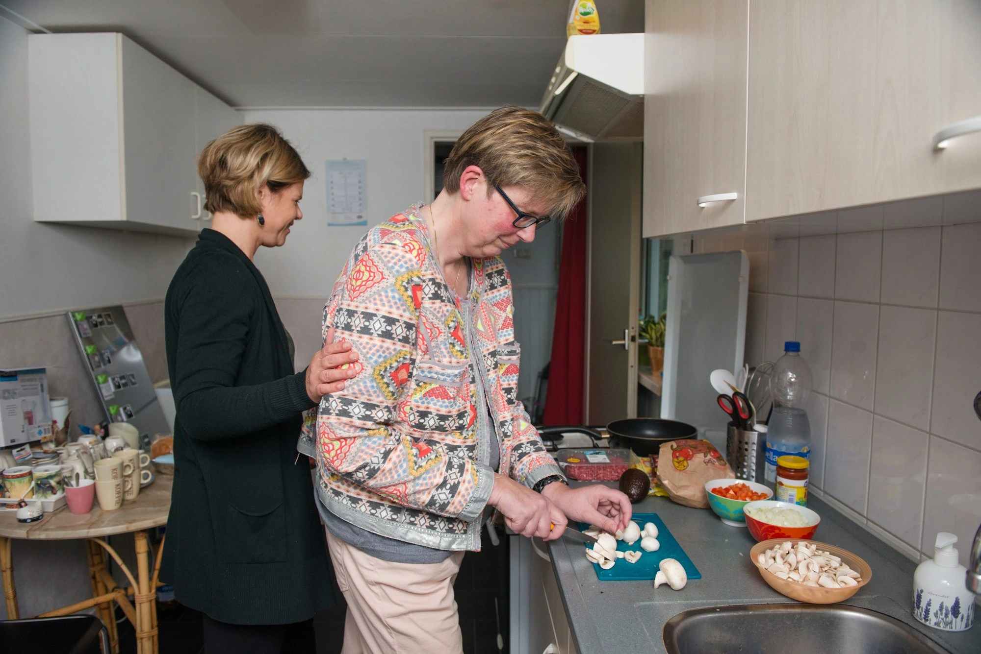 Medewerker en client in de keuken